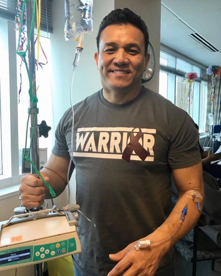 Willie Ng during cancer treatment beside his IV